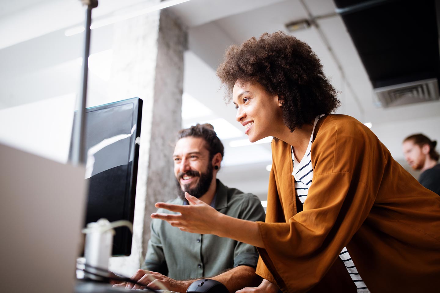 A multifamily marketing team collaborating on a laptop