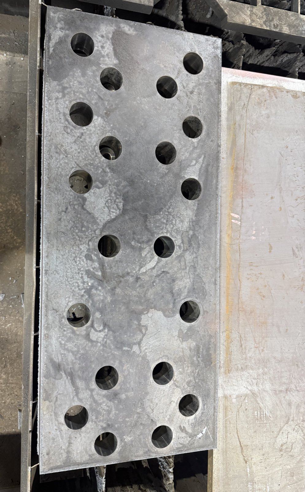 Thick steel plate with a drilled staggered hole pattern