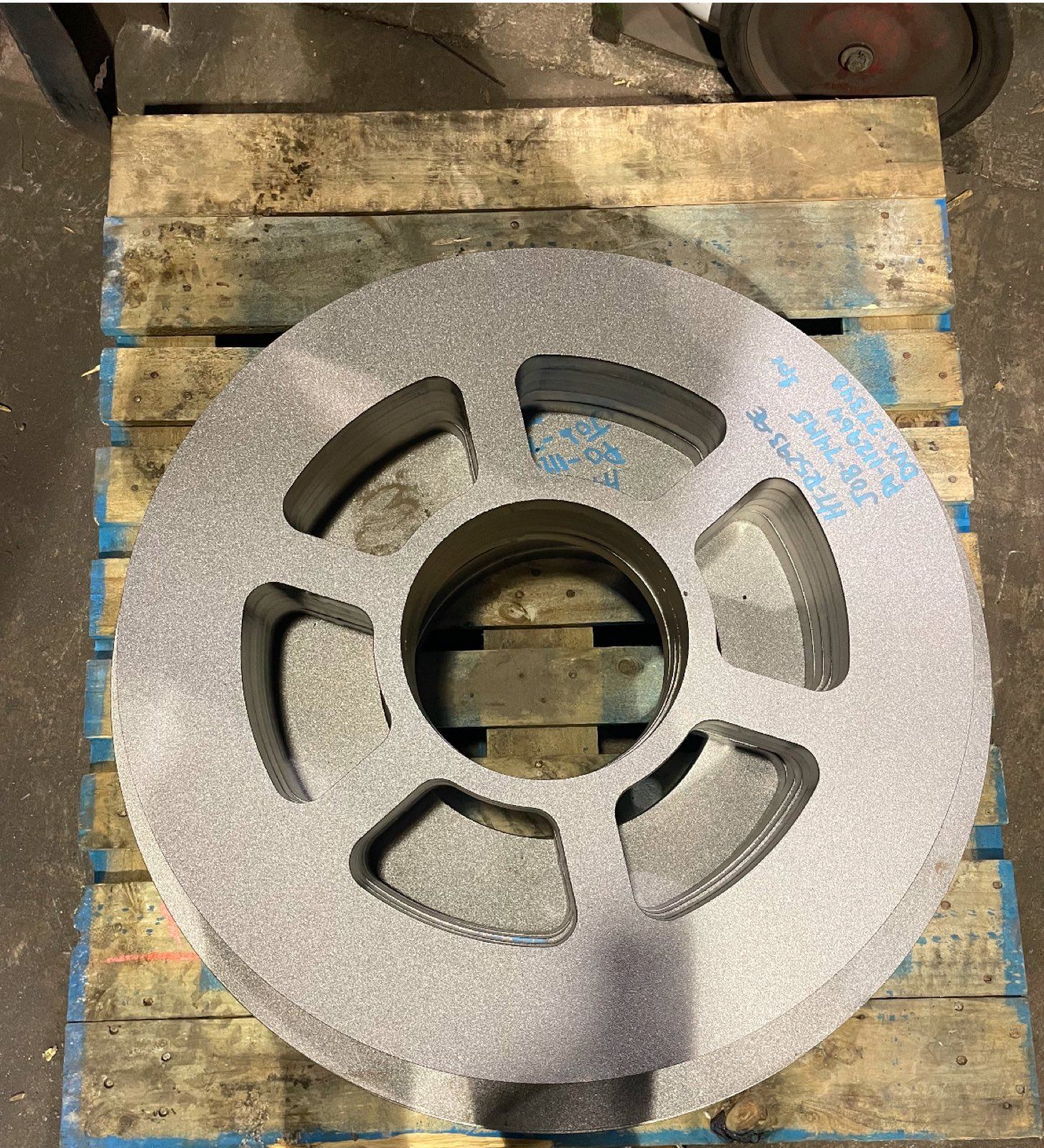 Shot-blasted steel wheel component finished on a pallet