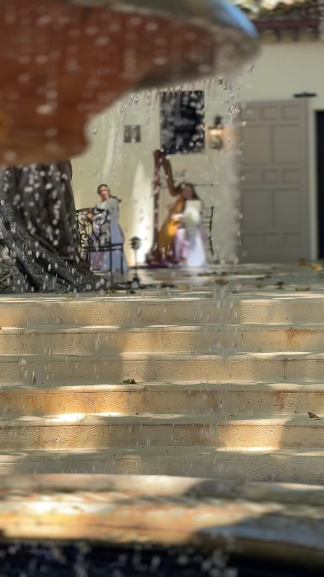 The Addison of Boca Raton Wedding Harpist and Violinist behind waterfountain
