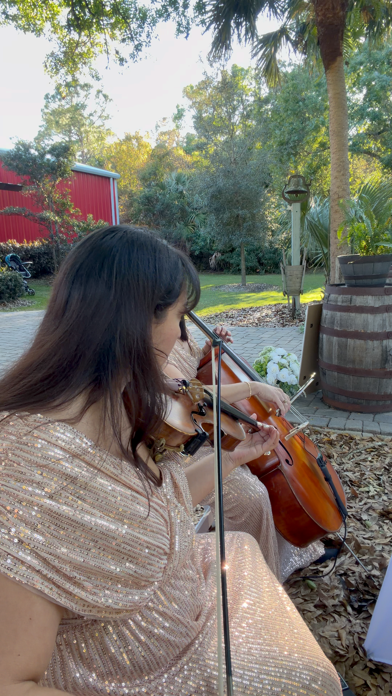 Violinist Vero Beach performing in a cello and violin duet in gold dresses