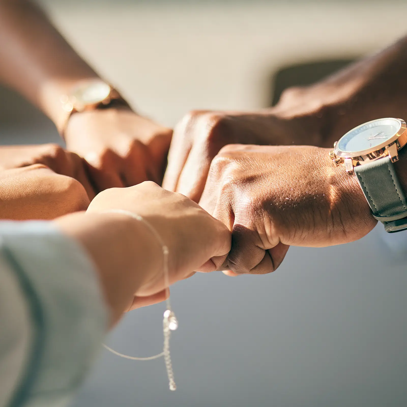 Team putting hands in the middle of a group