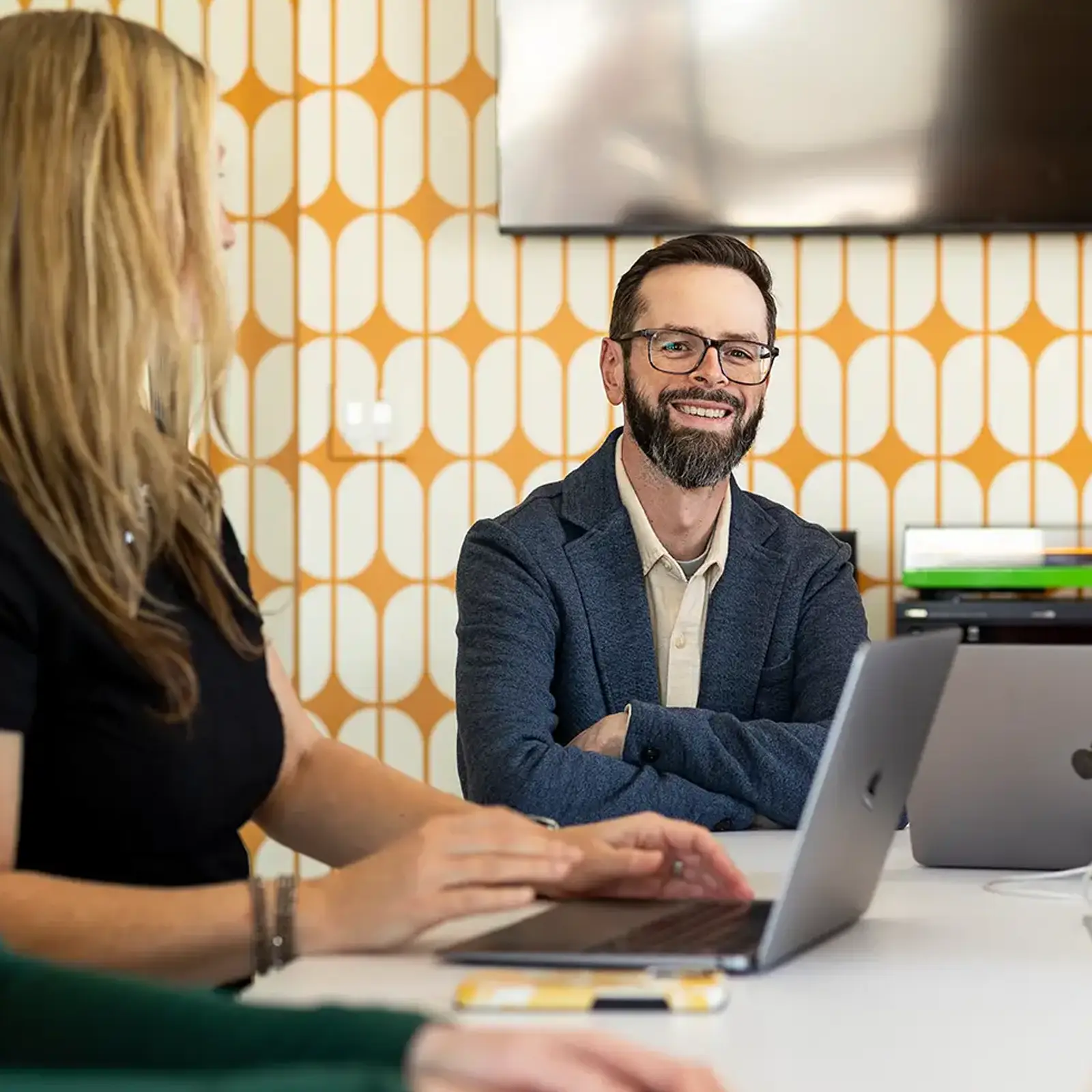 Kevin Whitbeck sitting at a conference table in a discussion.